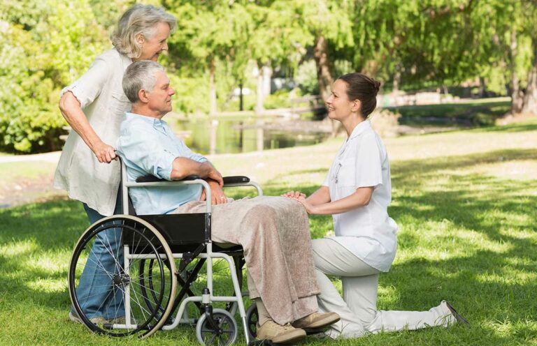 Proveer at Grande View | Women with mature man sitting in wheel chair at park